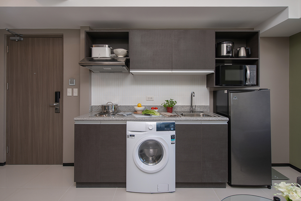 Serviced residences with washer and dryer in small kitchen.