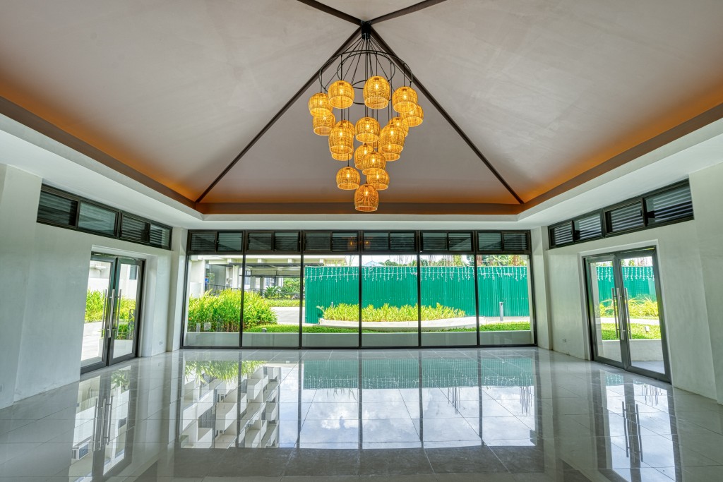actual view inside the pavilion with a chandelier and glass doors at Tierra Lorenzo Lipa