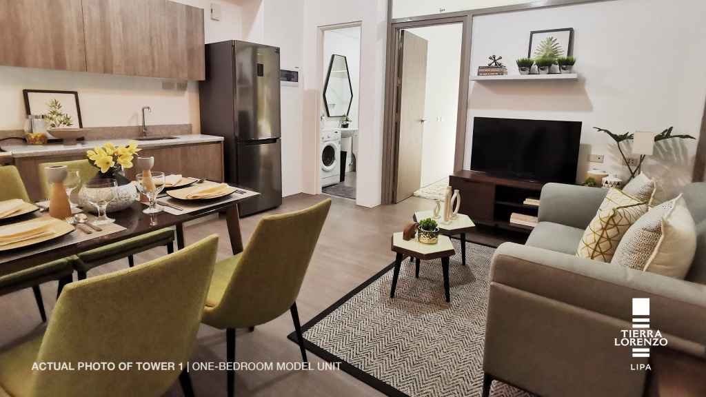 a living room with a television and a couch in the 1 BR Adria Tower at Tierra Lorenzo Lipa