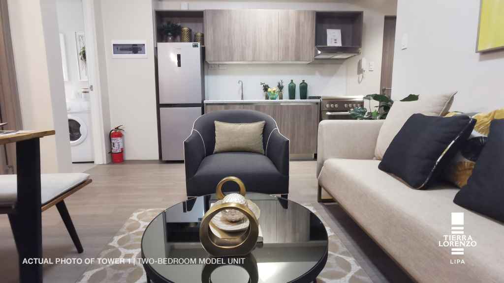 a living room with a couch and a coffee table in the 2BR Adria Tower at Tierra Lorenzo Lipa